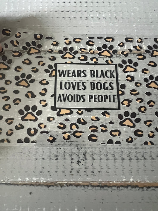 Wears black. Loves dogs. Avoids people